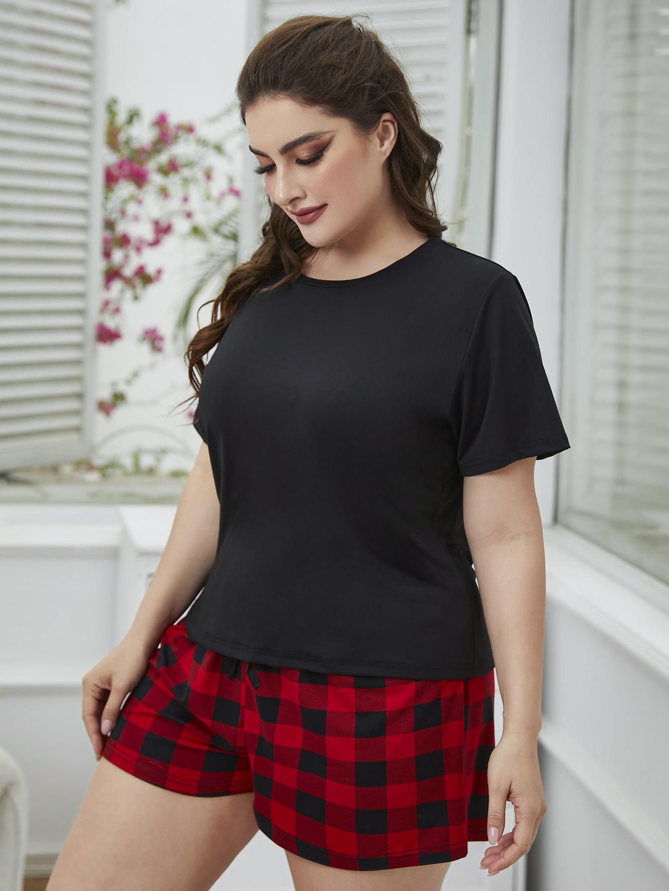 Soft black short-sleeve top paired with red and black plaid shorts, plus size