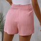 Chic pink high-waist skort with a flattering tie feature, blending elegance with comfort for everyday wear.