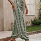 Green drawstring pants featuring a stylish bohemian print