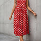 Sleeveless red dress adorned with white daisy motifs