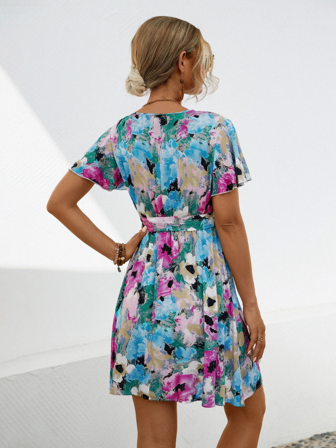 Shop the Printed Surplice Tie Waist Mini Dress – perfect blend of elegance, comfort, and vibrant style for any spring occasion.