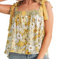 Embrace boho charm with our Yellow Floral Knot Top, perfect for a sunny day out. Lightweight, adjustable, and effortlessly stylish