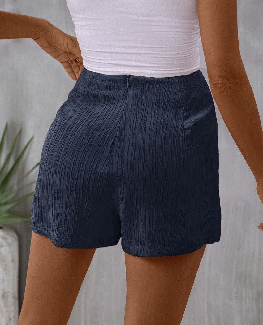 Chic navy high-waist skort with a flattering tie feature, blending elegance with comfort for everyday wear.