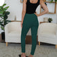 A pair of dark green high-waist pants with a chic, button-accented design.