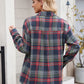 Women’s dark navy plaid shirt styled casually with rolled sleeves.
