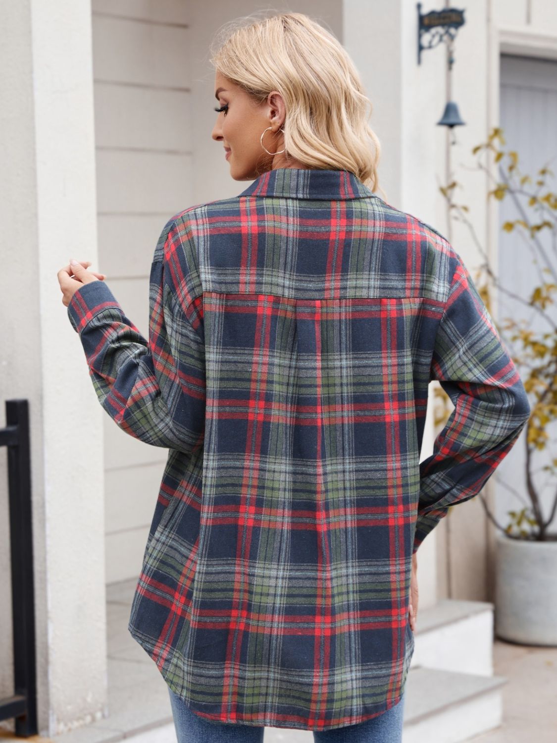 Women’s dark navy plaid shirt styled casually with rolled sleeves.
