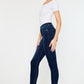 Women's dark wash jeans with frayed ankle hems by Kancan.