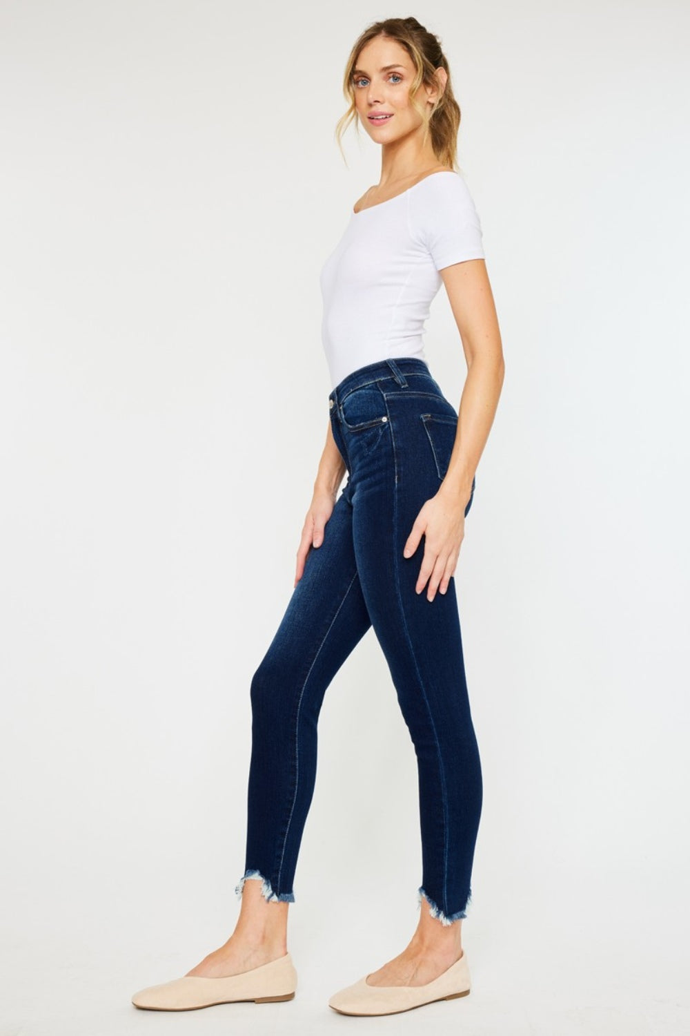 Women's dark wash jeans with frayed ankle hems by Kancan.