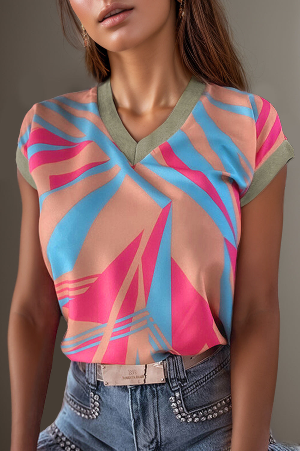 Stylish V-neck cap sleeve blouse with vibrant stripes for a chic, versatile look. Perfect for work or play