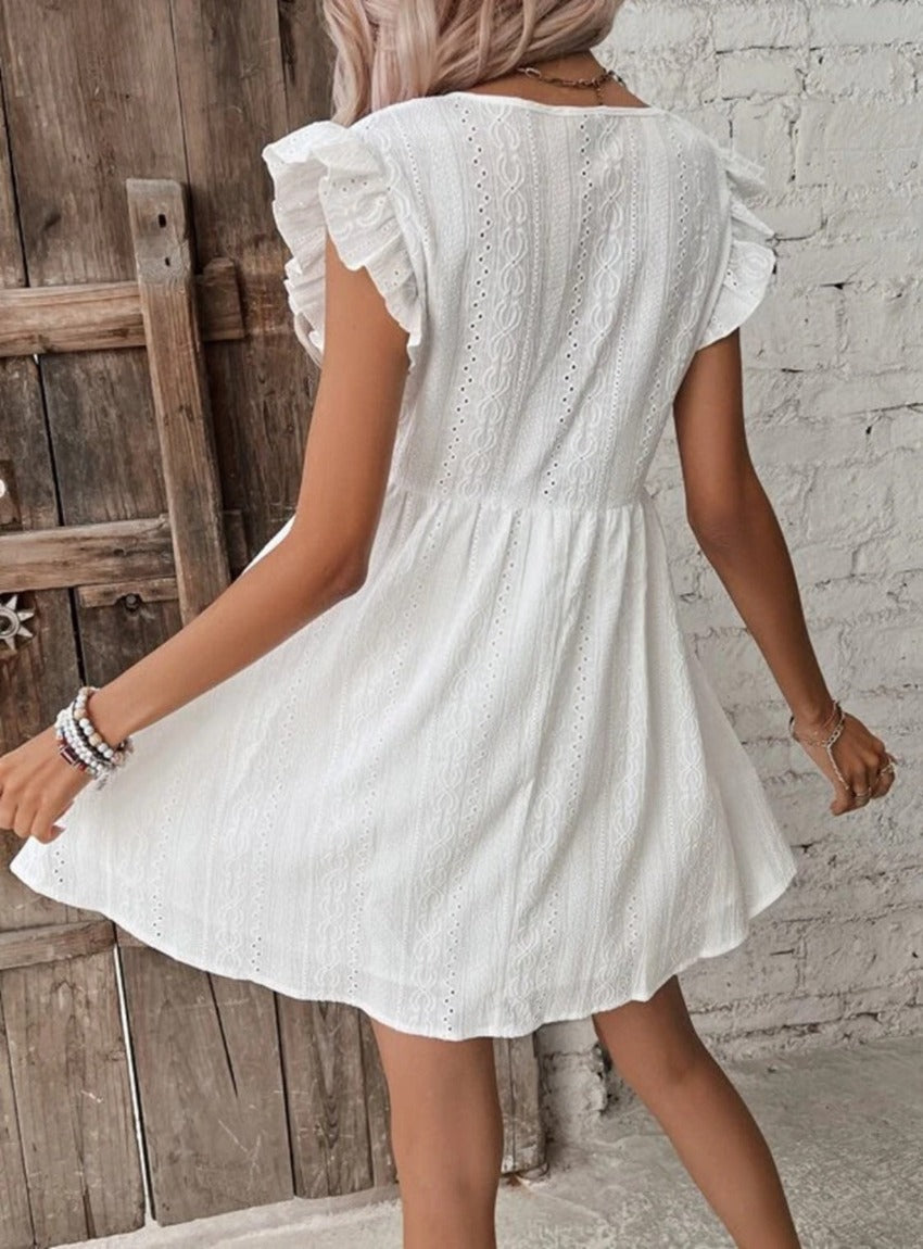 Chic Eyelet Mini Dress with ruffled sleeves & flattering empire waist. Perfect for any occasion. Breezy, elegant & effortlessly stylish.