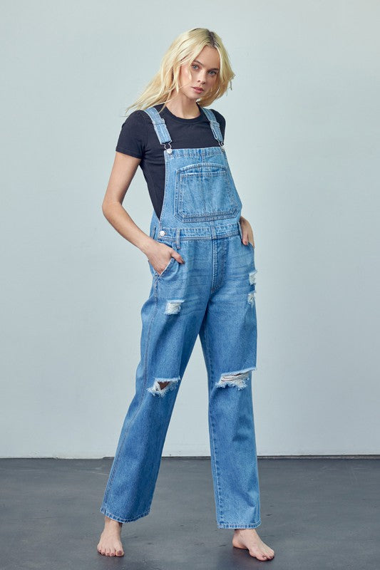 Women’s high-waist ripped denim overalls with functional patch pockets.
