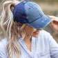 Navy distressed messy bun hat cap with ponytail opening
