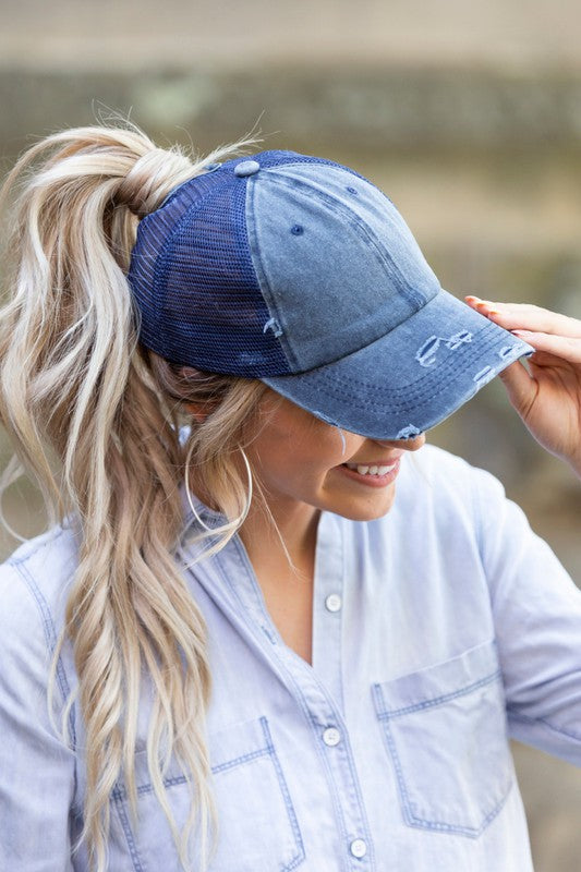 Navy distressed messy bun hat cap with ponytail opening
