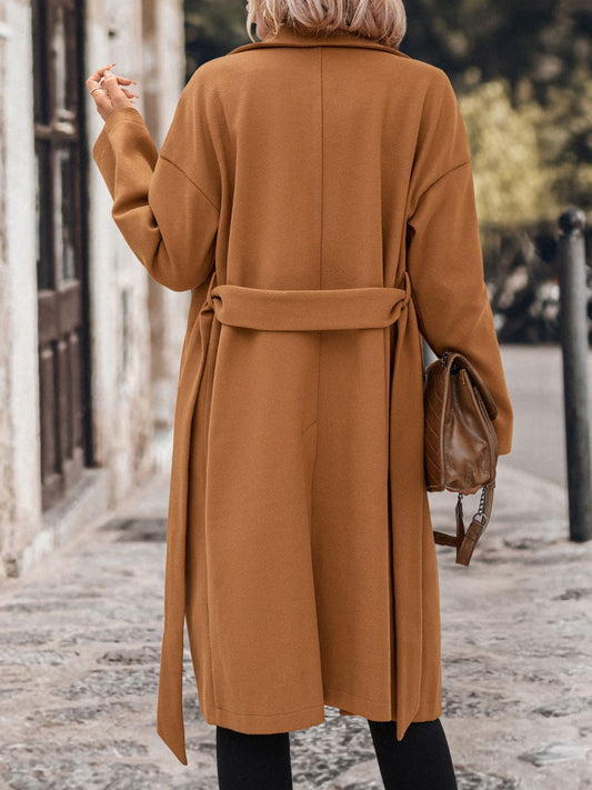 Double-breasted camel trench coat for women, ideal for fall and winter layering.
