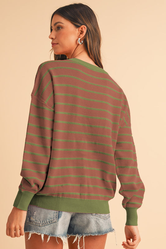 Mocha round-neck sweater with striped pattern and soft fabric.
