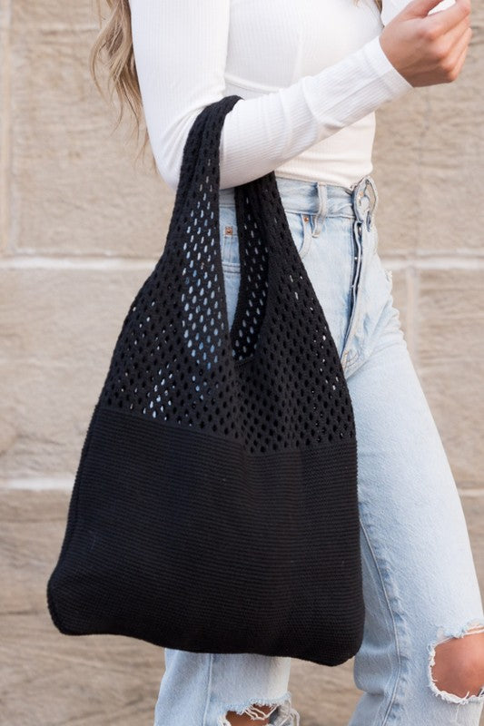 Durable and stylish black knit hobo bag, ideal for errands or shopping trips.
