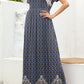 Navy blue maxi dress with bold floral design and border detailing