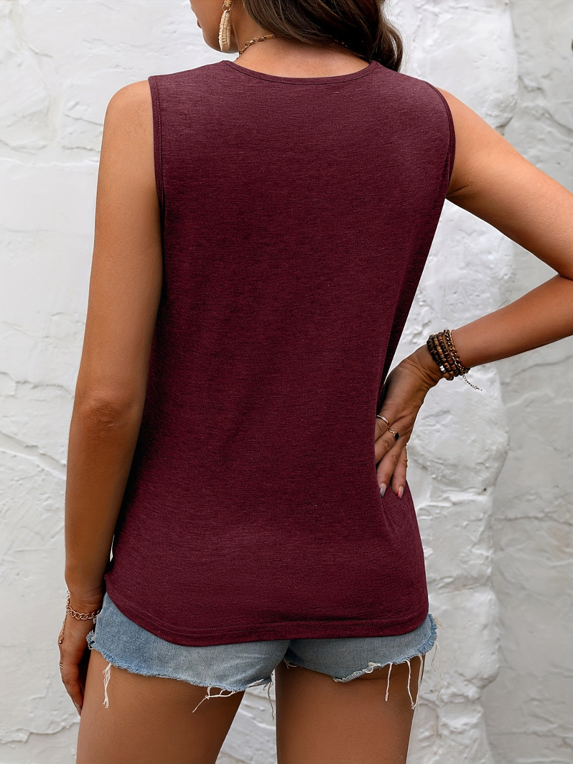 Stylish maroon sleeveless top with delicate black lace neckline, paired with distressed denim shorts for a chic summer look