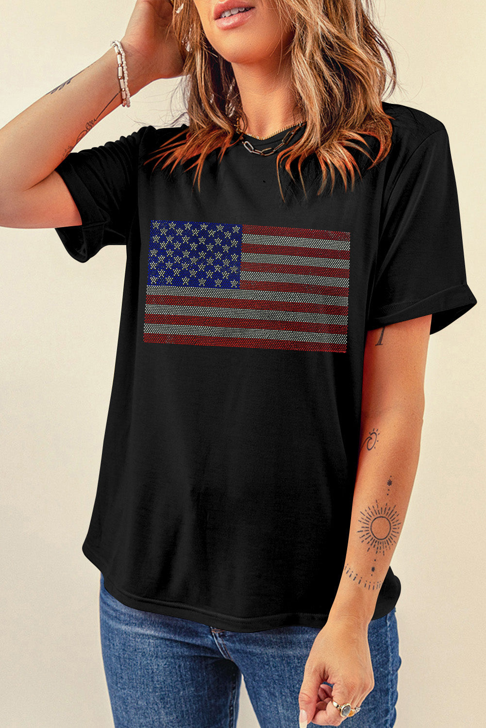 Sparkle in this Black Rhinestone American Flag Tee! Perfect blend of patriotism and style for any casual or celebratory occasion.