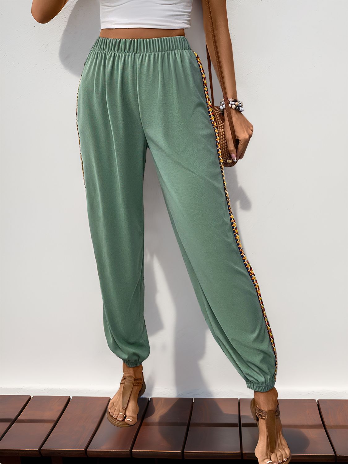 Relaxed fit sage jogger pants with embroidered side stripe.