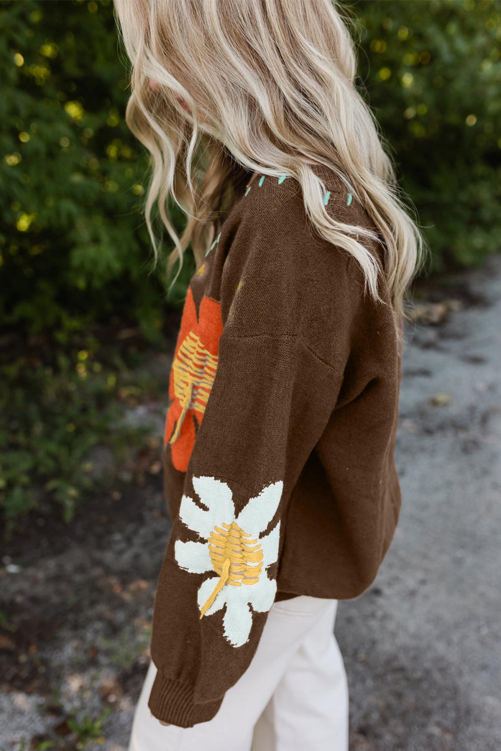 Close-up of brown sweater featuring vibrant flower designs and a V-neck | boho aesthetic
