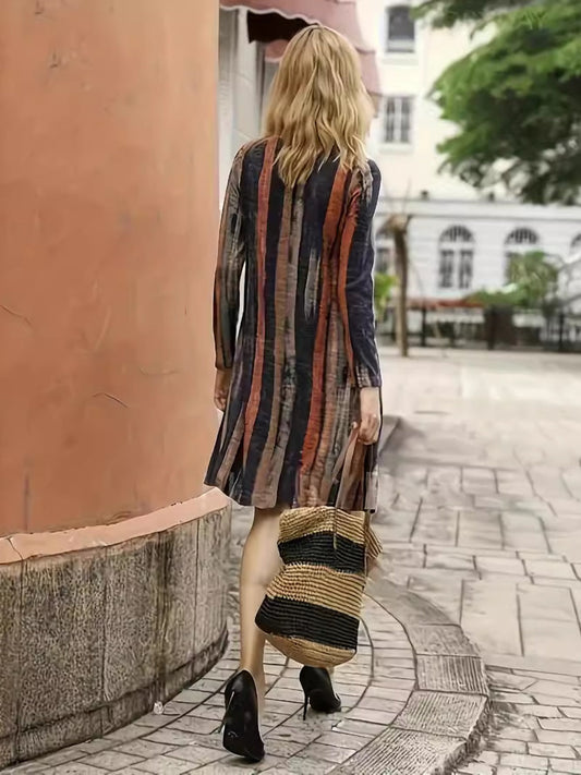 Women's boho swing dress with long sleeves and bold stripes.
