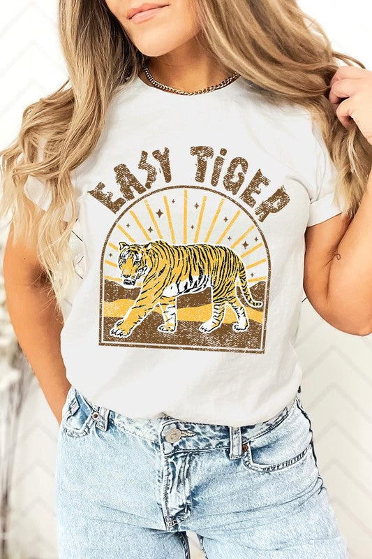 Woman showcasing her effortless style in a white "Easy Tiger" graphic t-shirt.