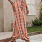 Pink drawstring pants featuring a stylish bohemian print