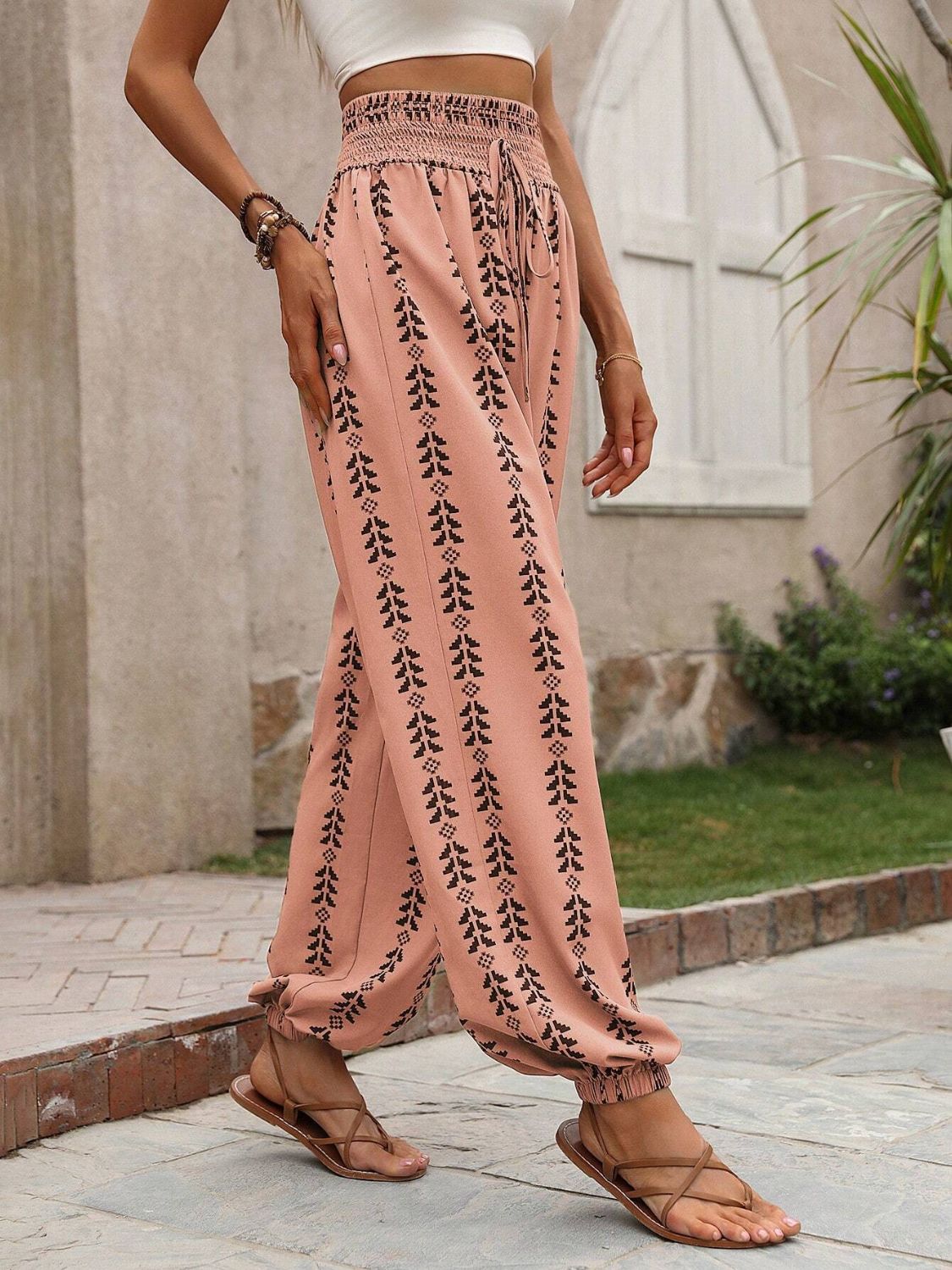 Pink drawstring pants featuring a stylish bohemian print