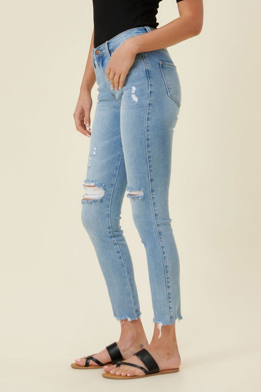 Trendy distressed skinny jeans with frayed hem
