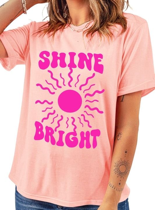 Comfortable pink graphic tee featuring "Shine Bright" in bright pink letters.