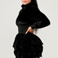 Elegant black dress with a mock neck and ruffled detailing, ideal for evening wear.
