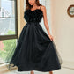 Elegant black feather sling dress styled for formal events and special occasions.
