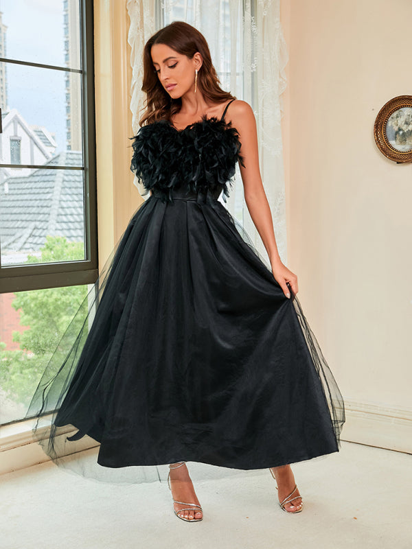 Elegant black feather sling dress styled for formal events and special occasions.
