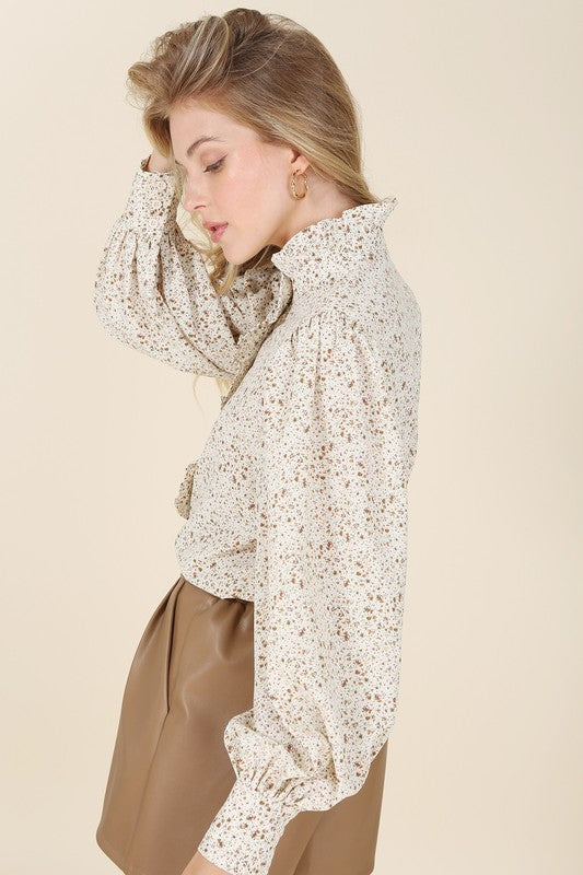 Elegant floral blouse featuring a stand collar design
