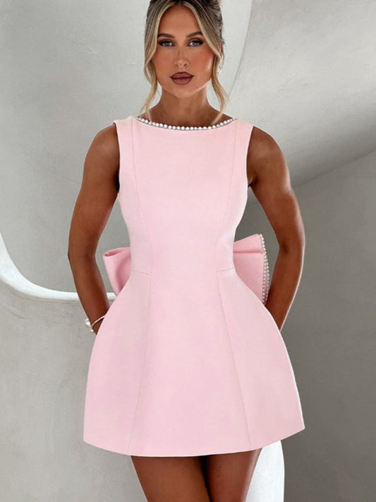 Elegant pearl bow A-line dress in pink with oversized back bow

