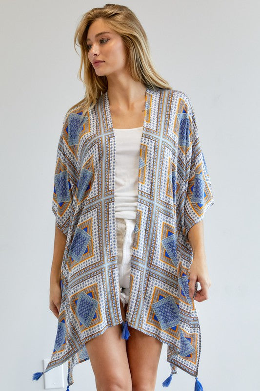 Sheer kimono featuring geometric designs in blue and yellow