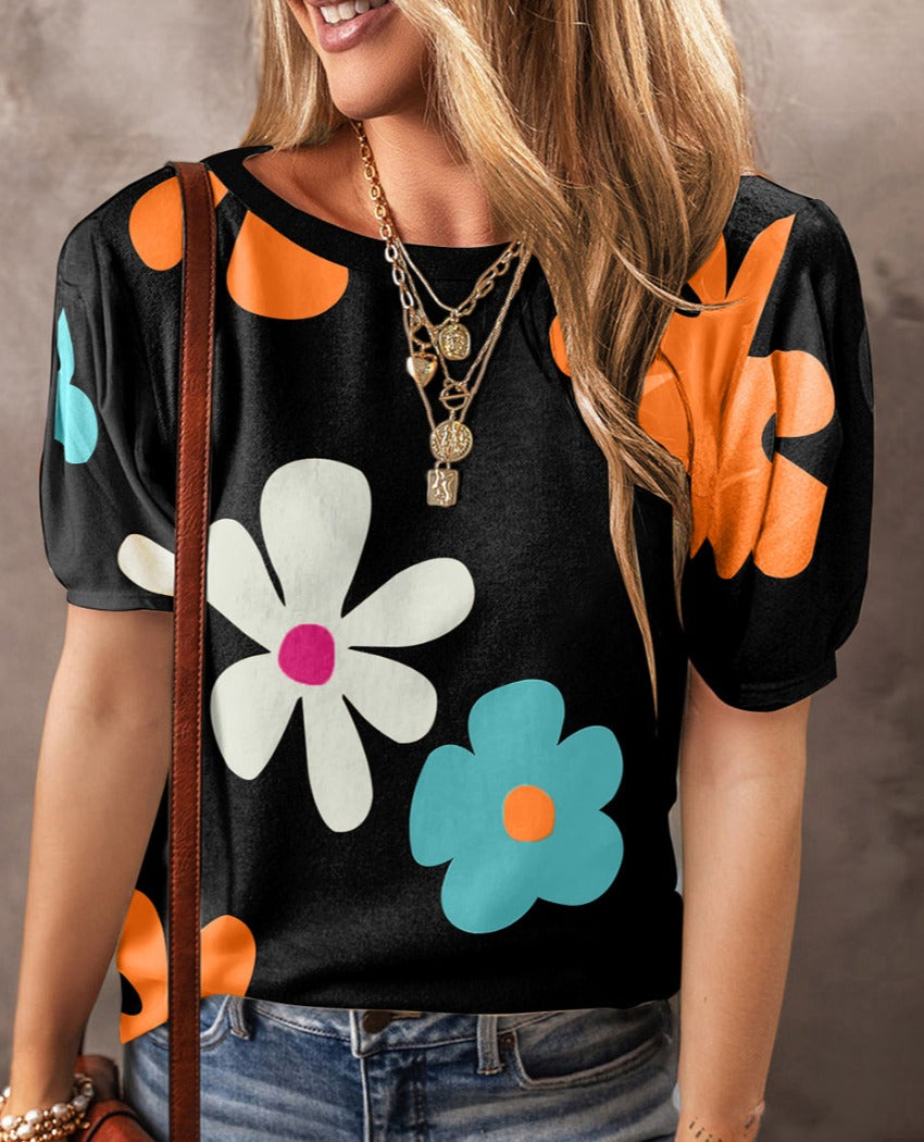 Vibrant short sleeve blouse with colorful floral print, perfect for adding a cheerful touch to any casual or semi-casual outfit.