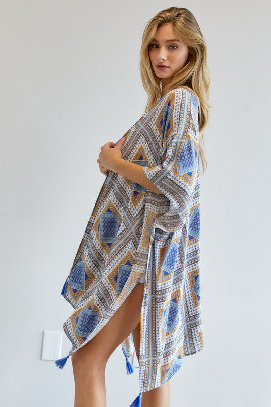 Geometric print kimono with playful tassels, available in yellow and blue