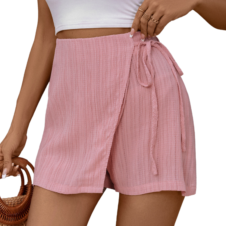 Chic pink high-waist skort with a flattering tie feature, blending elegance with comfort for everyday wear.