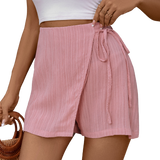 Chic pink high-waist skort with a flattering tie feature, blending elegance with comfort for everyday wear.