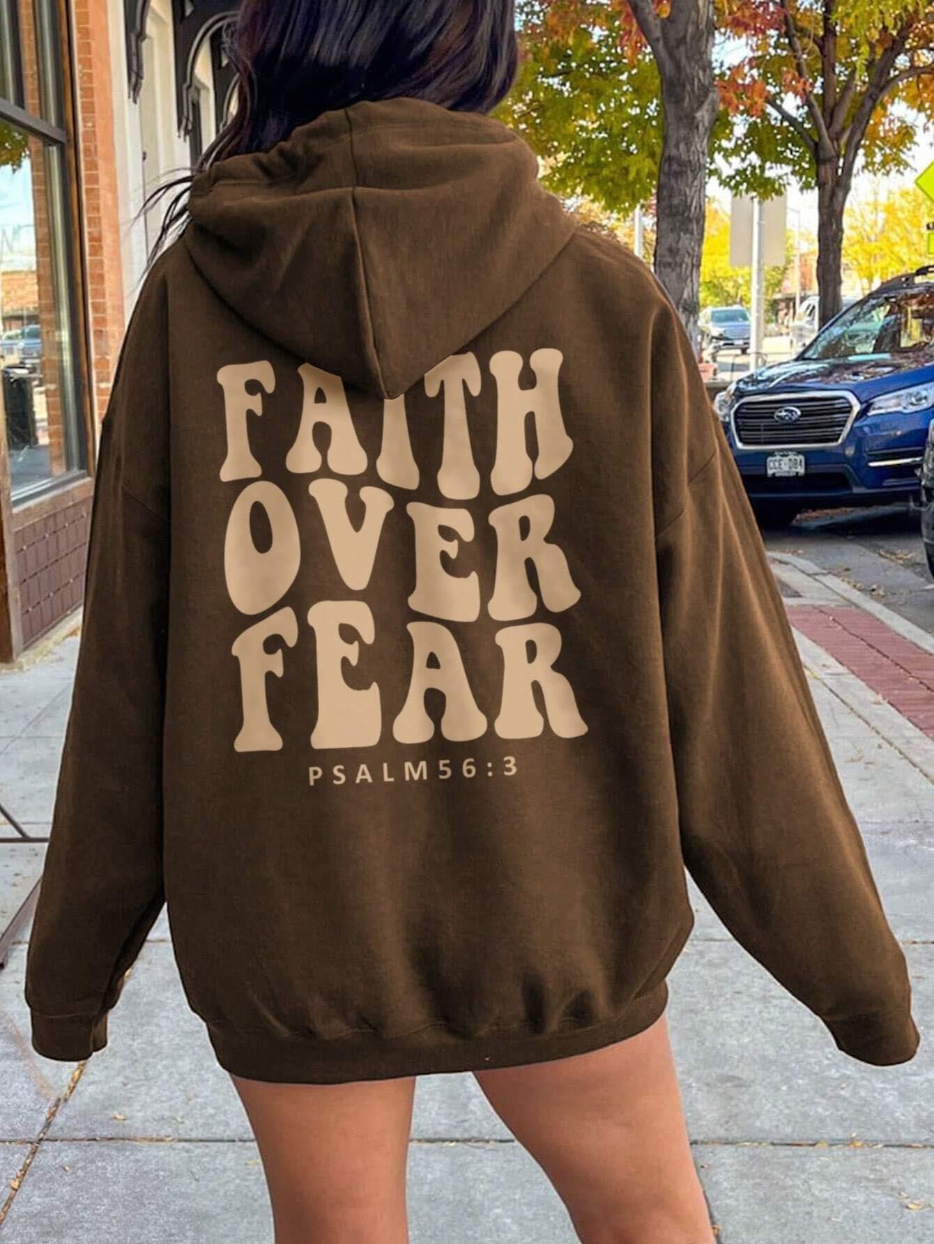 Brown oversized hoodie featuring "Faith Over Fear" with Psalm 56:3 printed on the back.