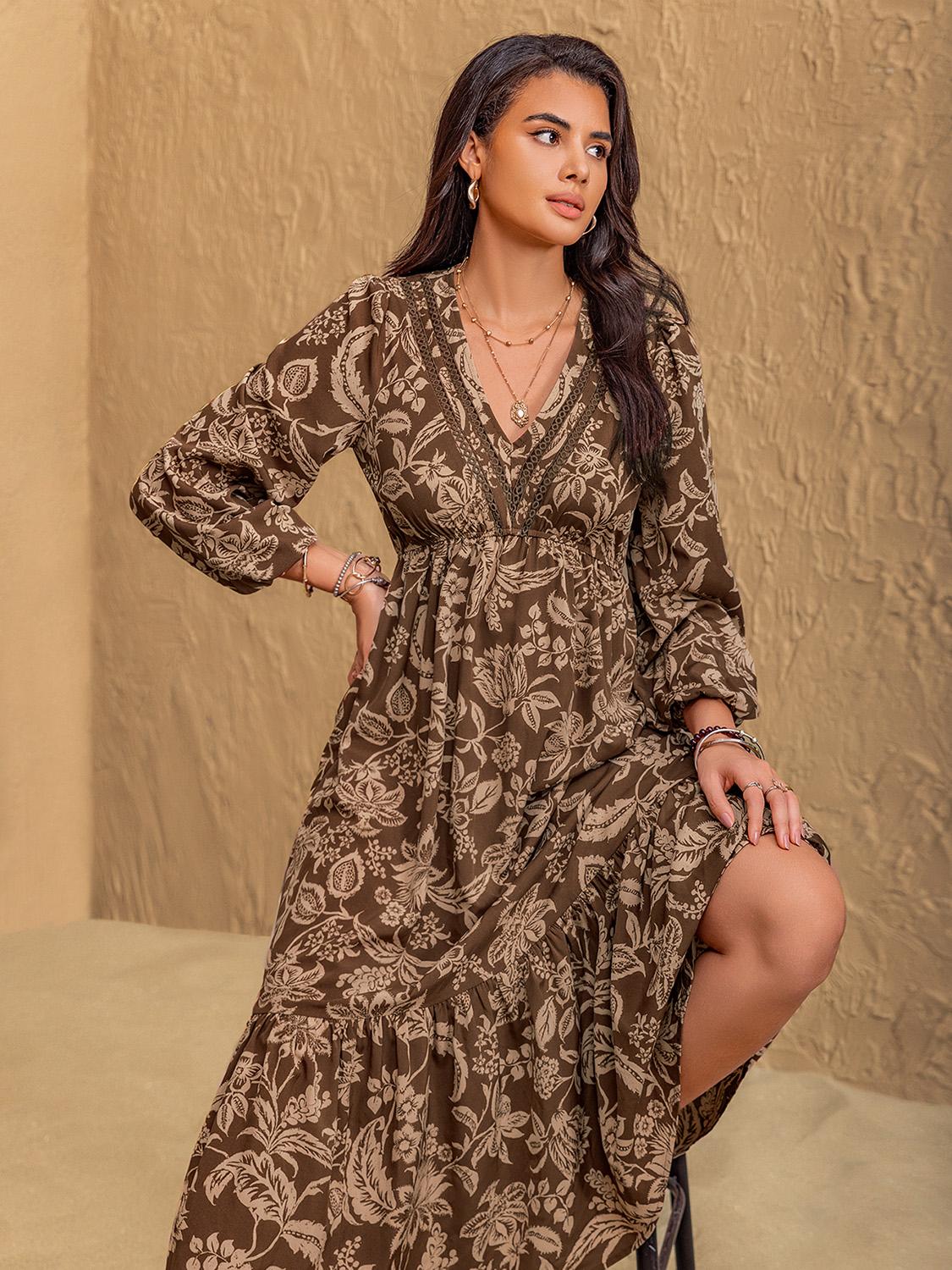 Woman posing in bohemian long sleeve V-neck printed midi dress.
