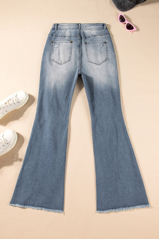 Fashionable high-rise distressed bootcut jeans for women with raw hem.