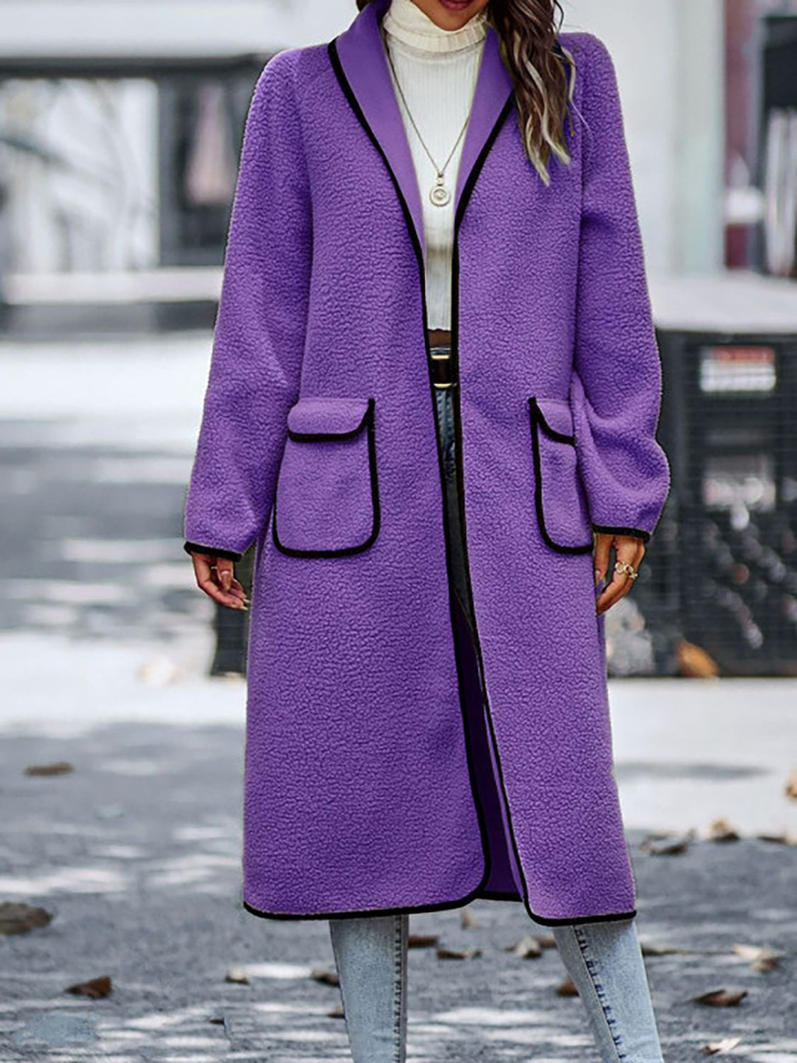 Fashionable long sherpa coat in purple, perfect for adding a pop of color.
