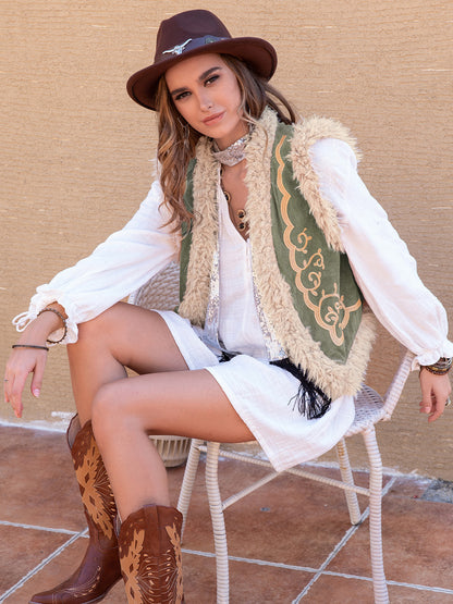 Close-up of embroidery and faux shearling trim on a boho vest.
