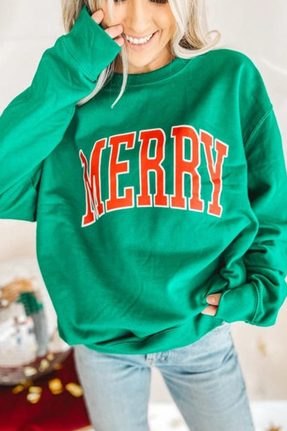 Festive green drop sleeve sweatshirt with “MERRY” print, perfect for holiday casual wear.
