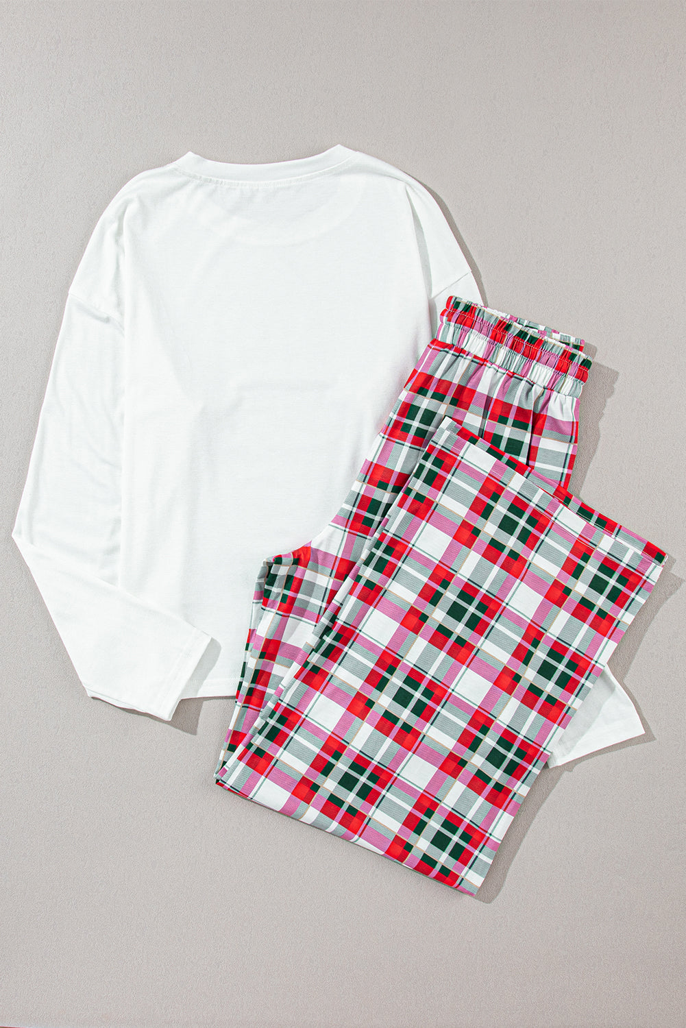 Holiday-themed plaid pajama set ideal for lounging or gift-giving.
