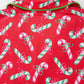 Festive pajama set featuring a candy cane pattern with green trim and a comfortable fit.
