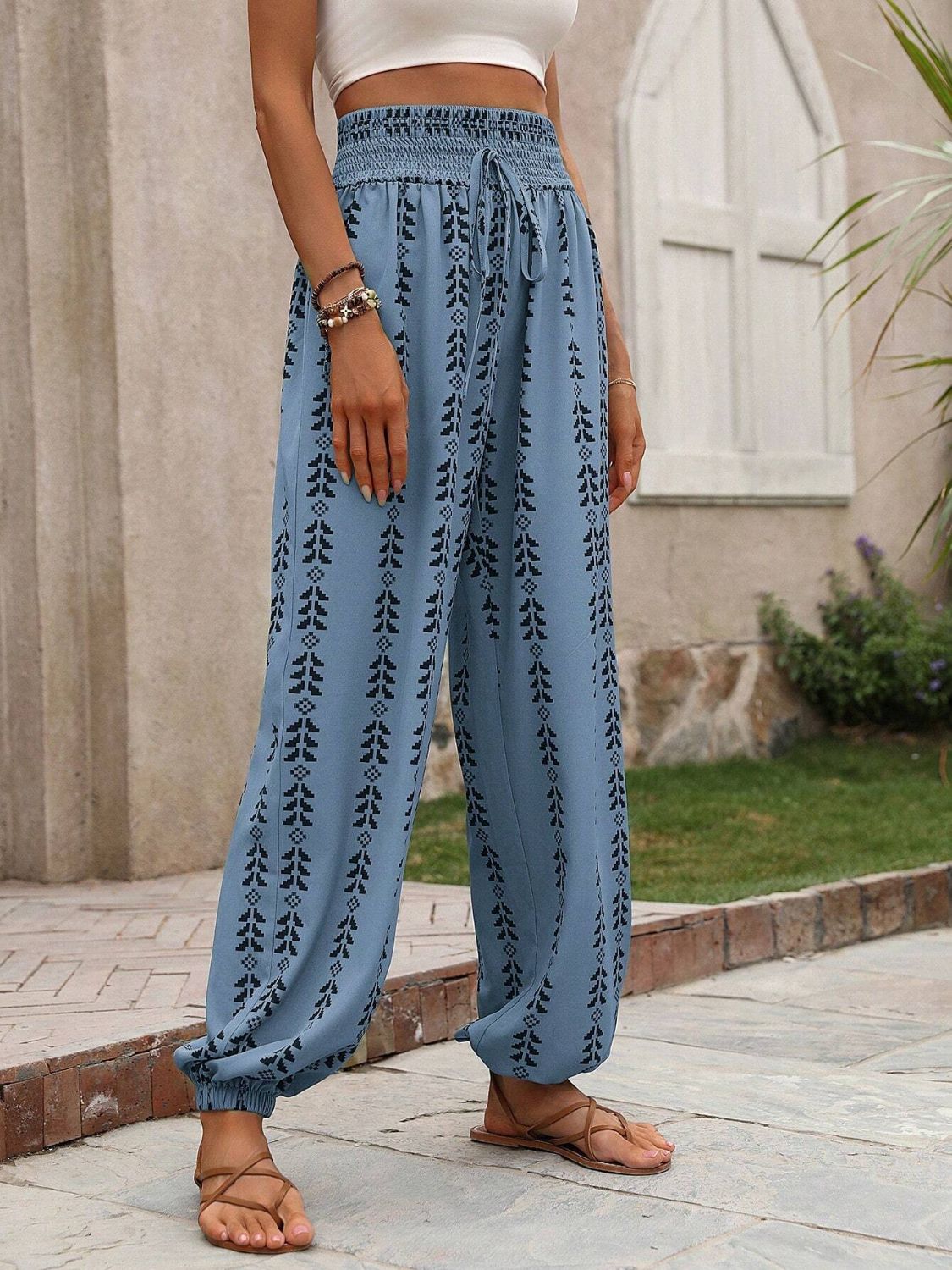 Blue drawstring pants featuring a stylish bohemian print